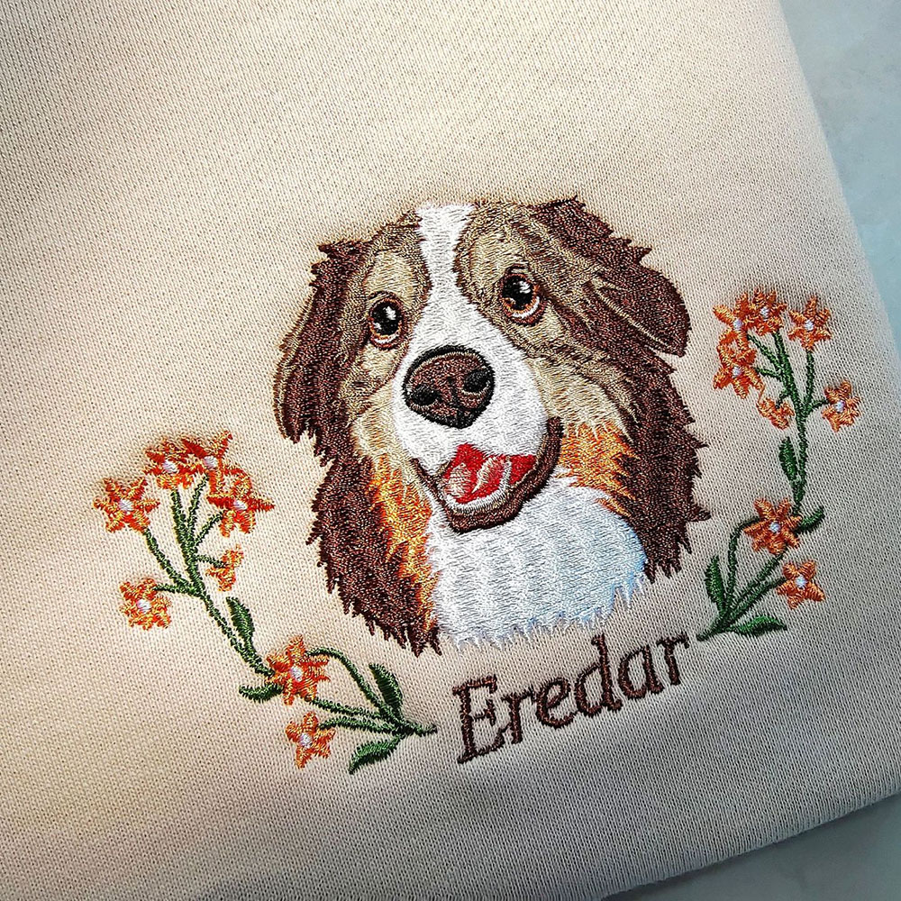 The hoodie features an embroidered print of the dog clearly displayed.