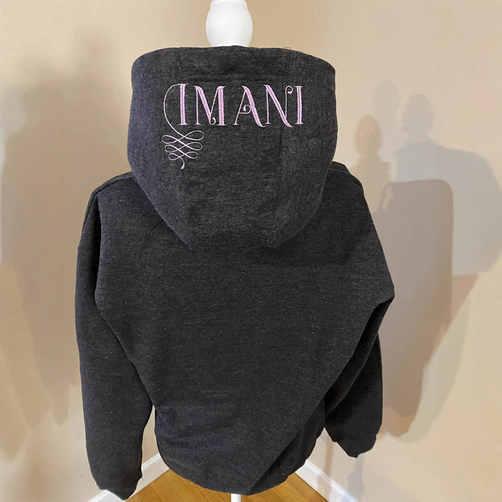 Warm hoodie with pink embroidered print on the hood