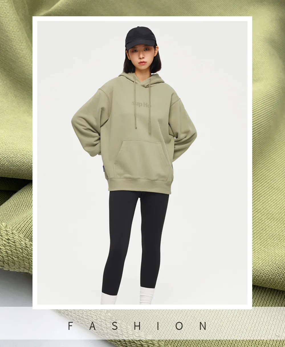 The model wears a hoodie crafted from heavyweight French terry fabric.