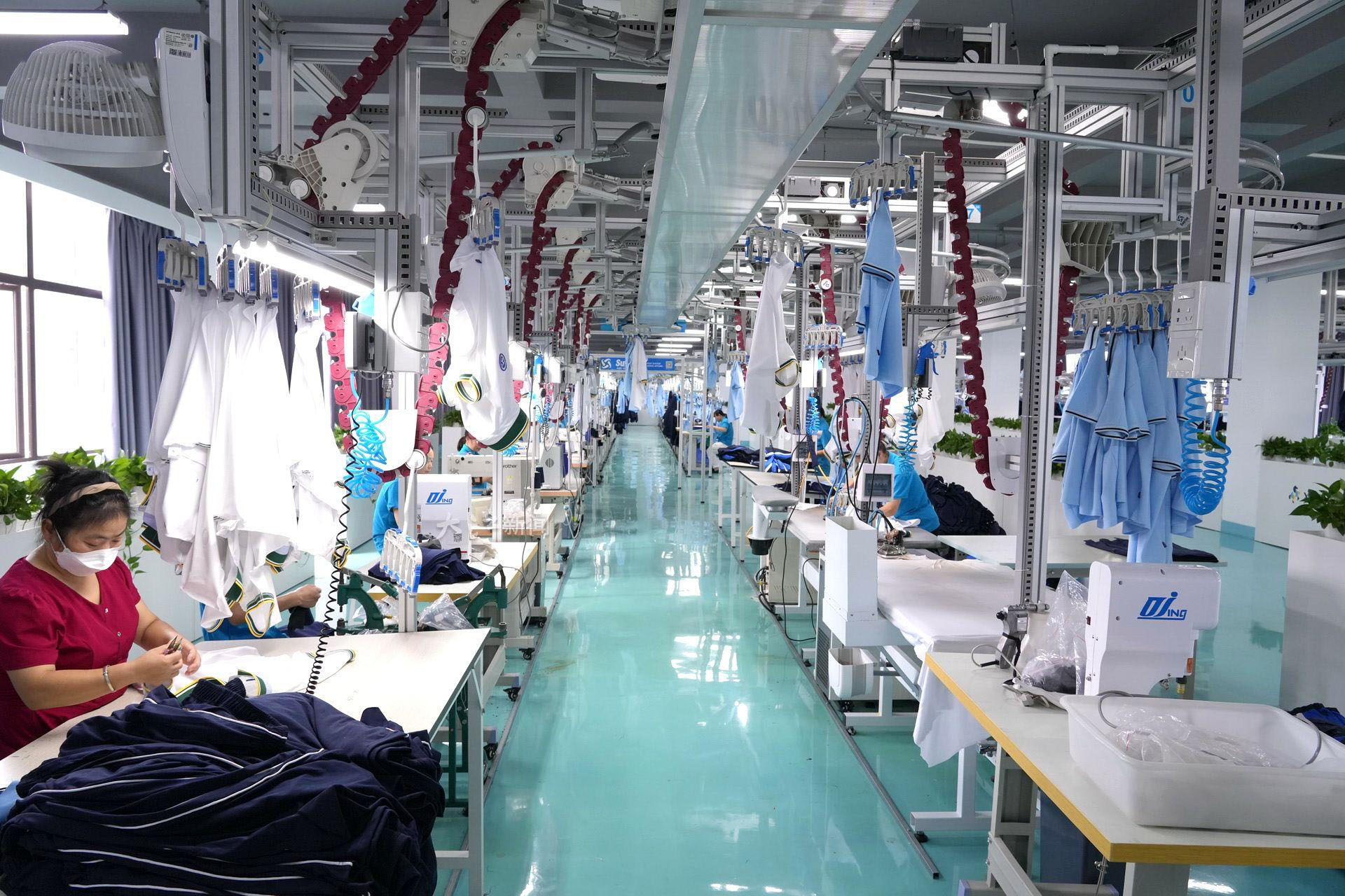 At a hoodie manufacturing factory in Guangdong, China, workers are producing T-shirts and hoodies on an assembly line.